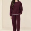 women's sweatshirt with side zippers and matching wide-leg trousers displayed as a two-piece set