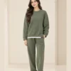 Woman wearing an olive green crew-neck sweatshirt with side-zip details and matching wide-leg trousers