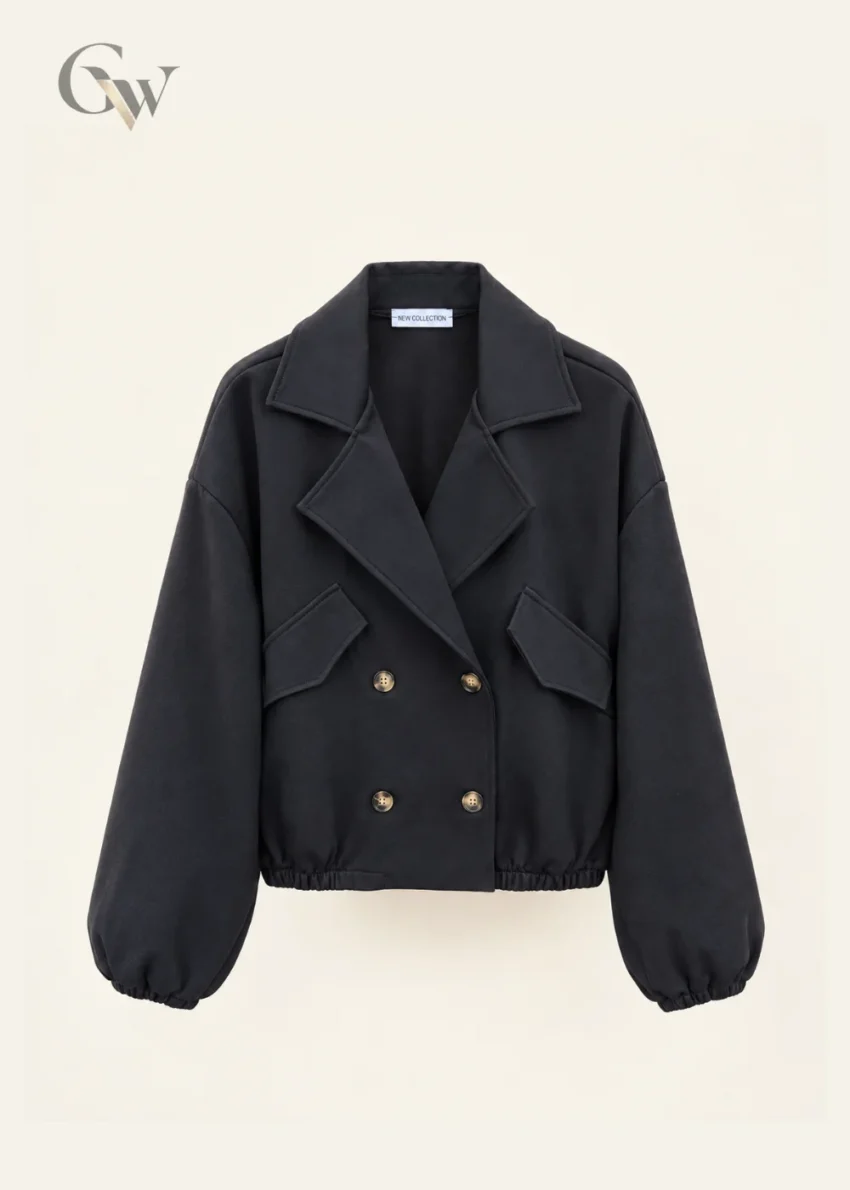 Woman wearing a black cropped double-breasted jacket with oversized lapels and four front buttons