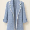 Women's blue and white patterned open-front jacket with lapel-style collar and contrasting light trim