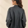 Woman wearing a black textured bomber jacket