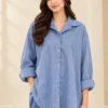 Woman wearing a Cowgirl Blue and white striped button-down shirt with a pointed collar and long sleeves.