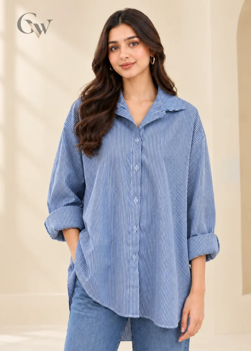 Woman wearing a Cowgirl Blue and white striped button-down shirt with a pointed collar and long sleeves.