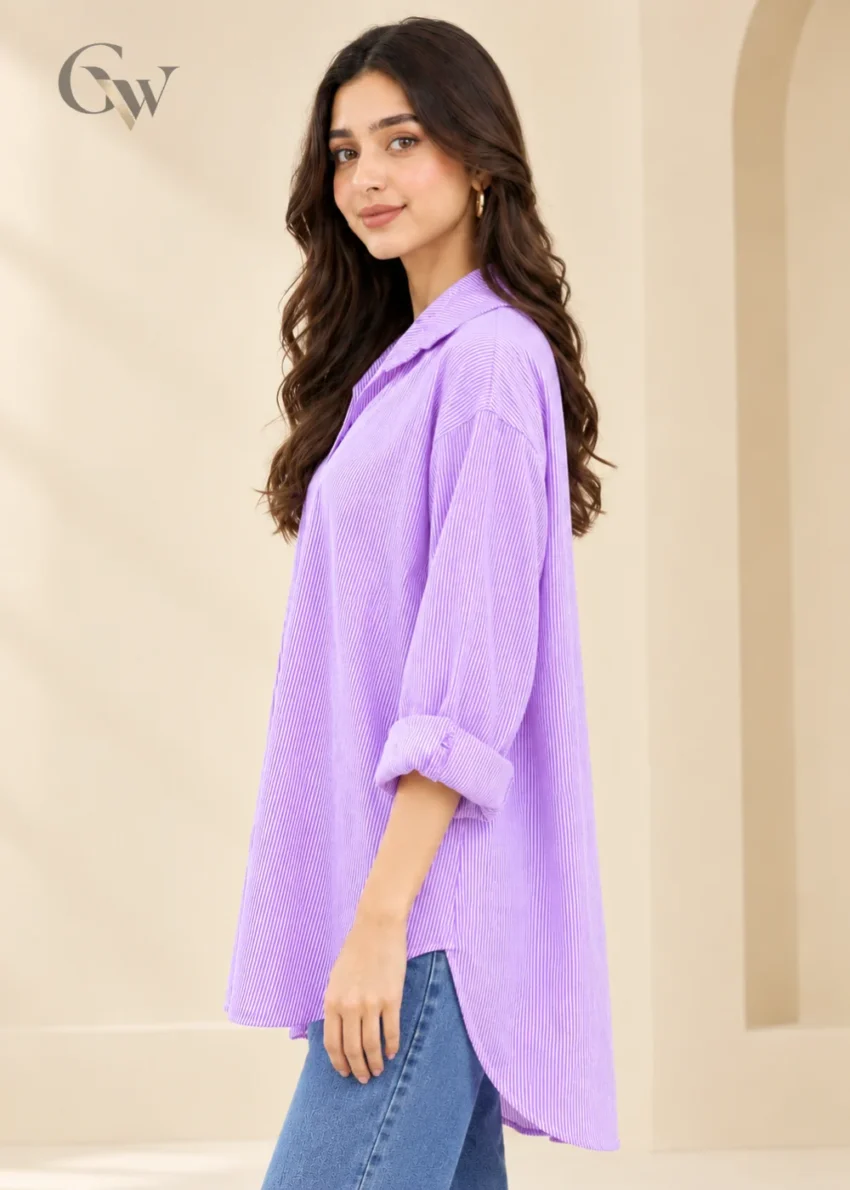 Woman wearing a lavender and white striped button-down shirt with a pointed collar and long sleeves.