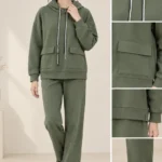 Woman wearing an olive green hooded co-ord set with white drawstrings and flap-detail pockets.